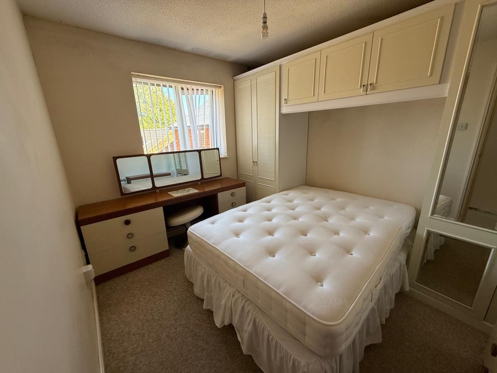 Lot: 124 - ONE-BEDROOM FLAT IN NEED OF IMPROVEMENT - Bedroom with fitted wardrobes around bed space